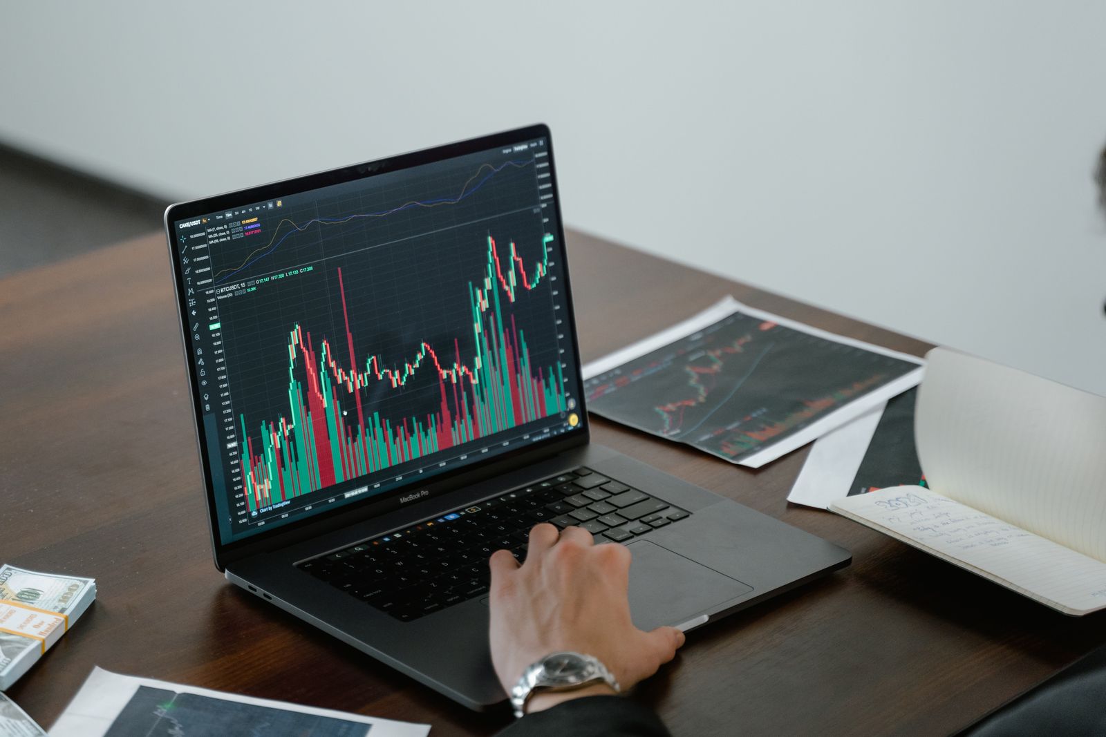 A laptop and printouts covered in analytics charts and line graphs, the kind of dashboards that show where viewers drop off but never explain why.