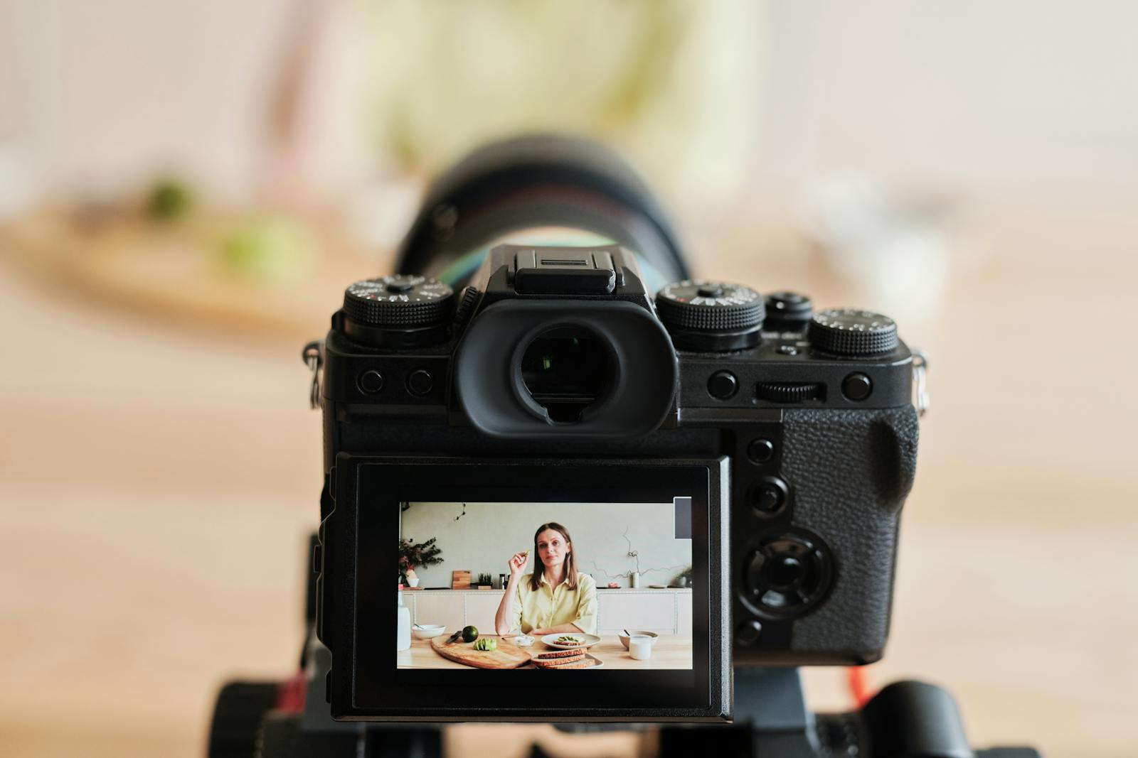 A creator filming a vlog at a kitchen counter on a phone, the everyday setup where good light and clean sound matter far more than an expensive camera.