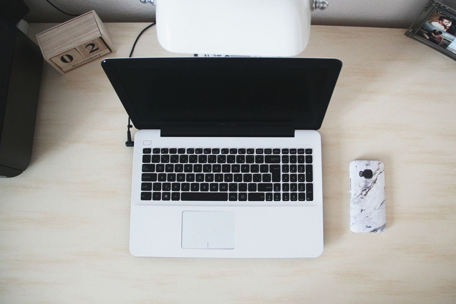 A phone, a tablet and a laptop laid out side by side on a desk, each showing the same video at a different size, the everyday problem of one cut needing to look right on every screen.