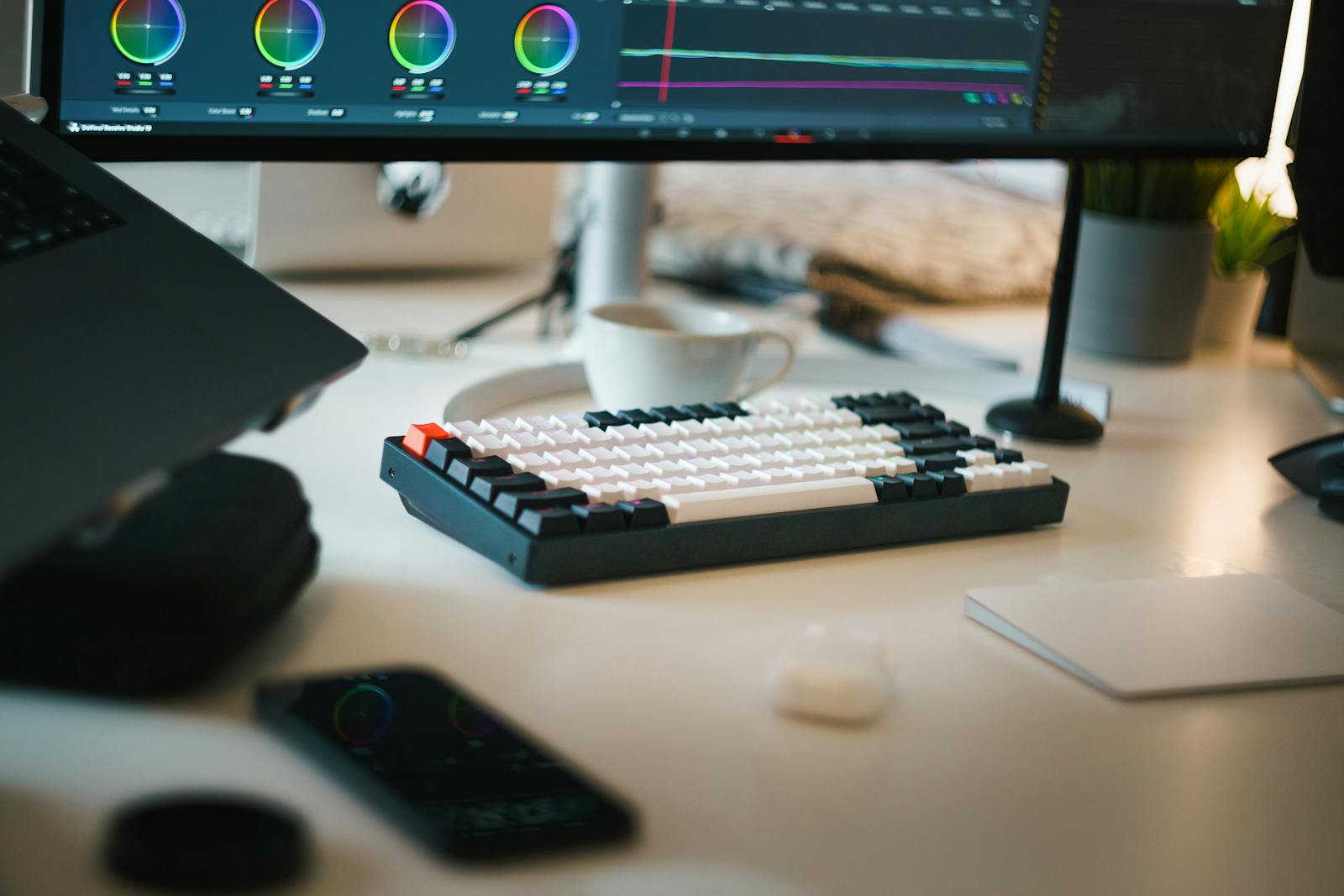 An editing desk lit by a timeline on the monitor, where the rhythm of an edit gets shaped shot by shot before it goes out.