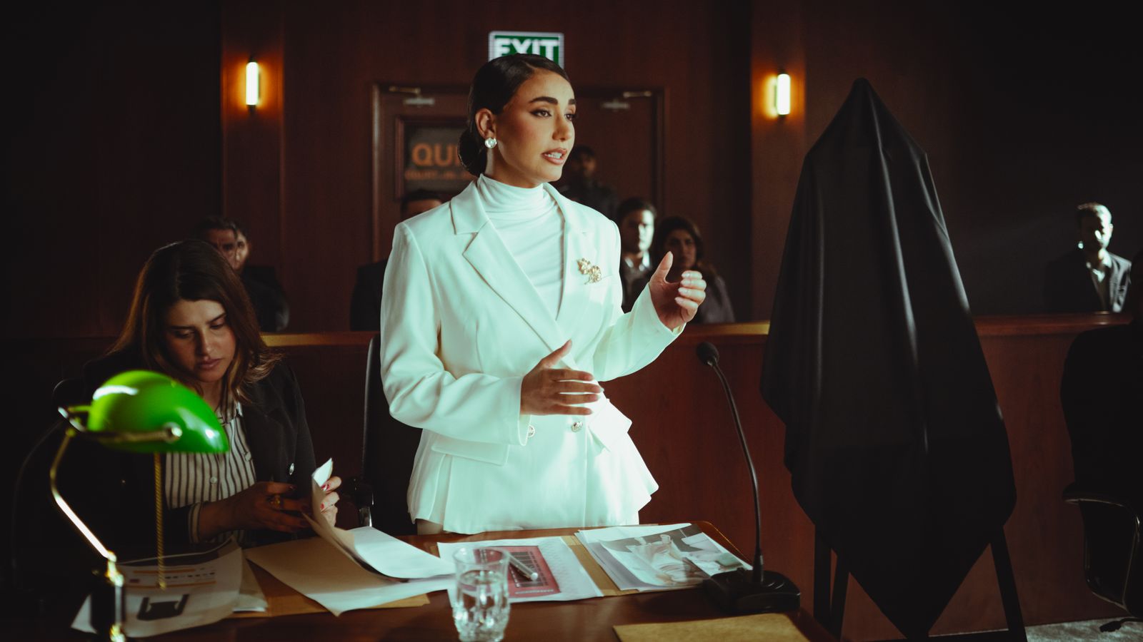 A presenter in a suit speaking to camera under controlled light, the kind of footage a professional reviewer pulls apart layer by layer before signing it off.