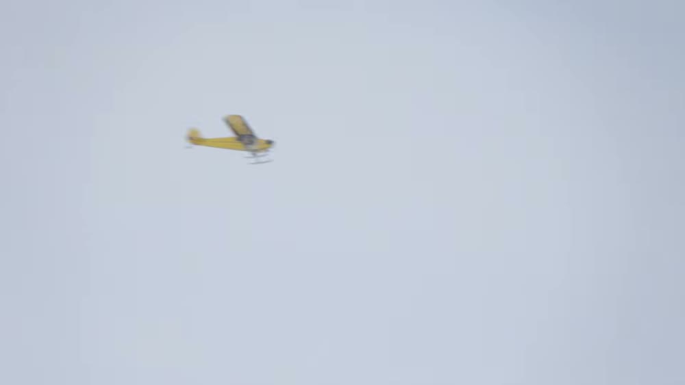 A small bush plane against a flat white sky, visibly soft and out of focus