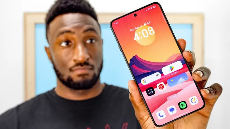 Marques Brownlee (MKBHD) presenting smartphones to camera in a studio