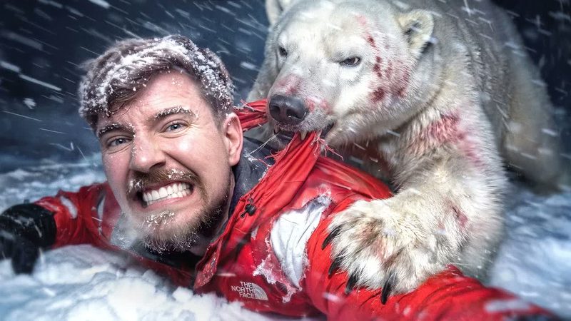 MrBeast in a red parka gritting his teeth as a snow-covered polar bear lunges in a blizzard